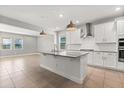 The kitchen offers a central island, granite countertops, and stainless steel appliances at 674 Anna Ridge Rd, Minneola, FL 34715
