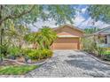 Charming single-story home with a well-manicured lawn and a paver driveway at 684 Grand Canal Dr, Kissimmee, FL 34759