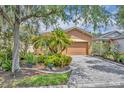 Charming single-story home with a well-manicured lawn and a paver driveway at 684 Grand Canal Dr, Kissimmee, FL 34759