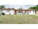 Inviting single-story house featuring a covered porch, perfect for enjoying the outdoors at 800 Jefferis Ct, Eustis, FL 32726