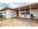 Inviting covered porch with tile flooring and comfortable seating, perfect for relaxing outdoors at 800 Jefferis Ct, Eustis, FL 32726