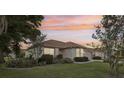 Attractive single-story home featuring lush landscaping, well-maintained lawn, and a neutral color scheme at 802 San Salvador Dr, The Villages, FL 32159