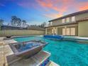 Backyard pool and spa with water features and a covered patio, perfect for outdoor entertaining at 8530 Vivaro Isle Way, Windermere, FL 34786