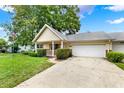 Well-kept home with an attached garage and lovely front yard landscaping at 8709 Sw 96Th St # A, Ocala, FL 34481