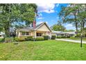 Inviting exterior of a cozy home with a green lawn and mature trees at 8709 Sw 96Th St # A, Ocala, FL 34481
