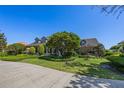 Scenic view of the home's exterior, complete with a driveway, lawn, and manicured landscaping at 9648 Weatherstone, Windermere, FL 34786