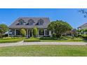 Beautiful exterior showcasing a well-maintained lawn and landscaped garden in front at 9648 Weatherstone, Windermere, FL 34786