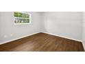 Bright bedroom with hardwood flooring and a window offering natural light at 9782 County Road 121, Wildwood, FL 34785