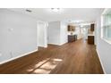 Spacious living room featuring hardwood floors and modern light gray walls at 9782 County Road 121, Wildwood, FL 34785