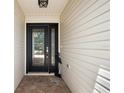 Inviting front entrance featuring a decorative glass door, sidelight, and elegant brick pavers at 1053 Alcove Loop, The Villages, FL 32162