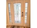 White front door with a glass design and windows on either side at 108 Whispering Pines Way, Davenport, FL 33837