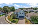 Beautiful curb appeal with lush landscaping on a sunny day showcases this lovely home at 1155 Dora Parc Ln, Mount Dora, FL 32757