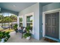 Relaxing front porch view features a bench, potted plants, and a glimpse of the fenced-in yard at 1155 Dora Parc Ln, Mount Dora, FL 32757