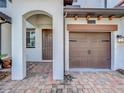 Inviting front entry featuring a brick paved driveway and a covered porch at 1342 Royal Saint George Blvd, Davenport, FL 33896