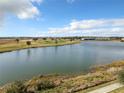 Scenic view of the golf course and pond from the property's elevated position at 1342 Royal Saint George Blvd, Davenport, FL 33896