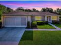 Charming single-story home featuring a well-manicured lawn and an attached two-car garage at 13875 Se 97Th Ave, Summerfield, FL 34491