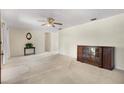 Spacious living room with neutral carpet, ceiling fan, and ample room for furniture arrangement at 1416 Abigail Dr, Apopka, FL 32703