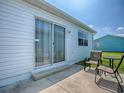 Relaxing patio with seating area just outside a sliding glass door at 1722 Moreno Pl, The Villages, FL 32159