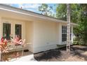 Home exterior with trimmed bushes, manicured mulch beds, double doors and a no soliciting sign at 1725 14Th St, Orange City, FL 32763