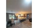 Open concept kitchen with stainless steel appliances, bar seating, and an adjacent dining area at 17873 E Highway 40, Silver Springs, FL 34488