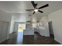 Open-concept kitchen featuring white cabinets, island with breakfast bar, and wood-look flooring at 2 Pine Terrace Way, Ocala, FL 34472