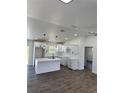 Bright, open kitchen features white cabinets, a center island, and modern finishes and fixtures at 2 Pine Terrace Way, Ocala, FL 34472