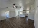 Open-concept living room featuring white walls, modern ceiling fan, and wood-look flooring at 2 Pine Terrace Way, Ocala, FL 34472