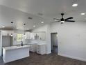 Open-concept living room with ceiling fan, recessed lighting, and kitchen with modern design at 2 Pine Terrace Way, Ocala, FL 34472