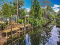 Scenic waterfront view featuring a wooden dock with stairs leading to a tranquil canal at 2216 River Ridge Rd, Deland, FL 32720