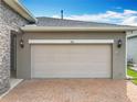 Attached two car garage with brick paver driveway at 224 Silver Maple Rd, Groveland, FL 34736