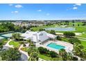 An aerial view of the community pool, tennis courts, and golf course at 2457 Upton St, The Villages, FL 32163