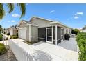 The backyard features a screen enclosed patio and a well maintained white fence at 2457 Upton St, The Villages, FL 32163