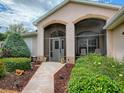 Inviting front porch with stone pathway and lush greenery, creating a welcoming entrance to the home at 3001 Lake Huron Ln, Tavares, FL 32778