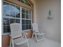 Relaxing front porch featuring comfortable white chairs, perfect for enjoying quiet moments outdoors at 3001 Lake Huron Ln, Tavares, FL 32778