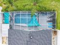 Aerial view of private screened pool, sunshades, patio furniture, and manicured landscaping at 310 Ballyshannon Dr, Davenport, FL 33897