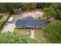 Expansive aerial view of the property showcasing lush greenery, mature trees, and large building at 39812 French Rd, Lady Lake, FL 32159
