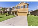 A well-manicured lawn complements the two-story home with an attached garage and simple shrubbery at 422 Rock Springs Cir, Groveland, FL 34736