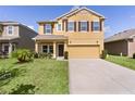 Charming two-story home with a well-maintained lawn and a two-car garage, perfect for Gathering living at 422 Rock Springs Cir, Groveland, FL 34736