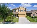 Two-story home with attached garage and simple landscaping providing an attractive curb appeal at 422 Rock Springs Cir, Groveland, FL 34736