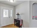 Inviting foyer with decorative tile flooring, an arched niche, and a stylish entry table at 4314 Arlington Ridge Blvd, Leesburg, FL 34748