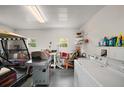 Spacious garage includes a washing machine and golf cart at 5300 Tigers Tail, Leesburg, FL 34748