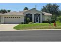 Beautiful one-story home featuring a manicured lawn and spacious two-car garage at 5300 Treasure View Way, Leesburg, FL 34748