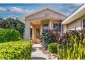 Inviting front entrance with a covered porch and attractive landscaping at 5324 Treasure View Way, Leesburg, FL 34748