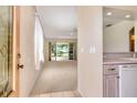 Bright and airy living room with sliding glass doors leading to the outdoors at 5324 Treasure View Way, Leesburg, FL 34748