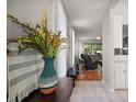 Bright hallway featuring tile flooring, leading into a naturally lit living room at 5604 Gulf Stream St, Tavares, FL 32778
