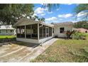 A well maintained home featuring a screened in back patio and a well manicured lawn at 5618 Rosewall Cir, Leesburg, FL 34748
