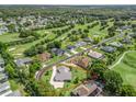 Aerial view of the property showcasing lush greenery, golf course views, and a well-defined lot line at 563 Dowling Cir, Lady Lake, FL 32159