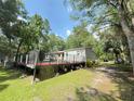 Enjoy the outdoors in this backyard with a partially screened pool and spacious deck, perfect for relaxation at 606 Hamilton Dr, Orlando, FL 32833