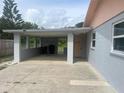 Covered carport is attached to the side of the house with laundry room door access at 640 Mansfield Rd, Tavares, FL 32778