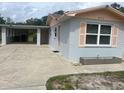The house with carport also features a small decorative planter box near the front door at 640 Mansfield Rd, Tavares, FL 32778